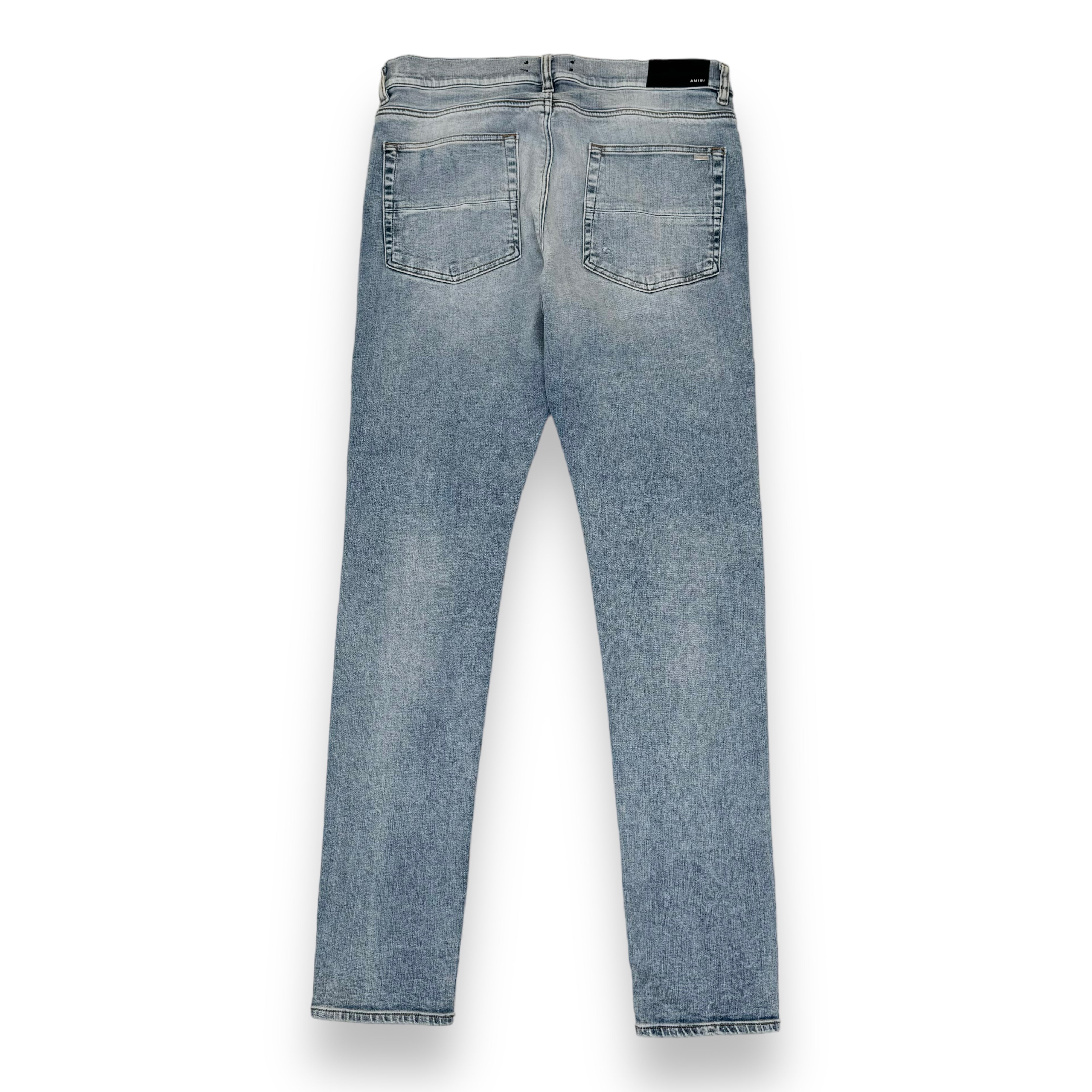 AMIRI DISTRESSED LEATHER PATCH WASHED DENIM JEANS BLUE 36W