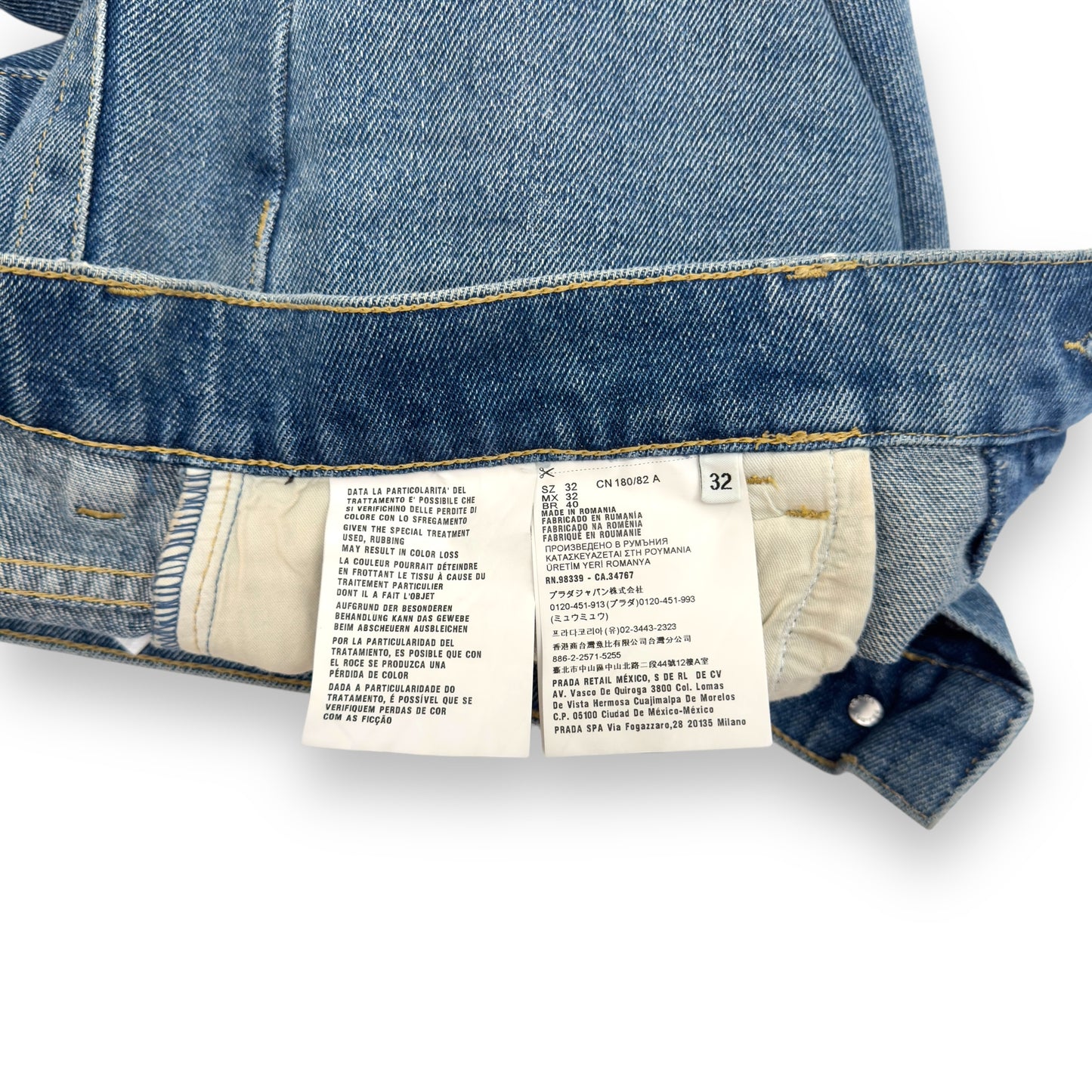 PRADA TRAINGLE-LOGO PLAQUE DISTRESSED DENIM JEANS BLUE W32”