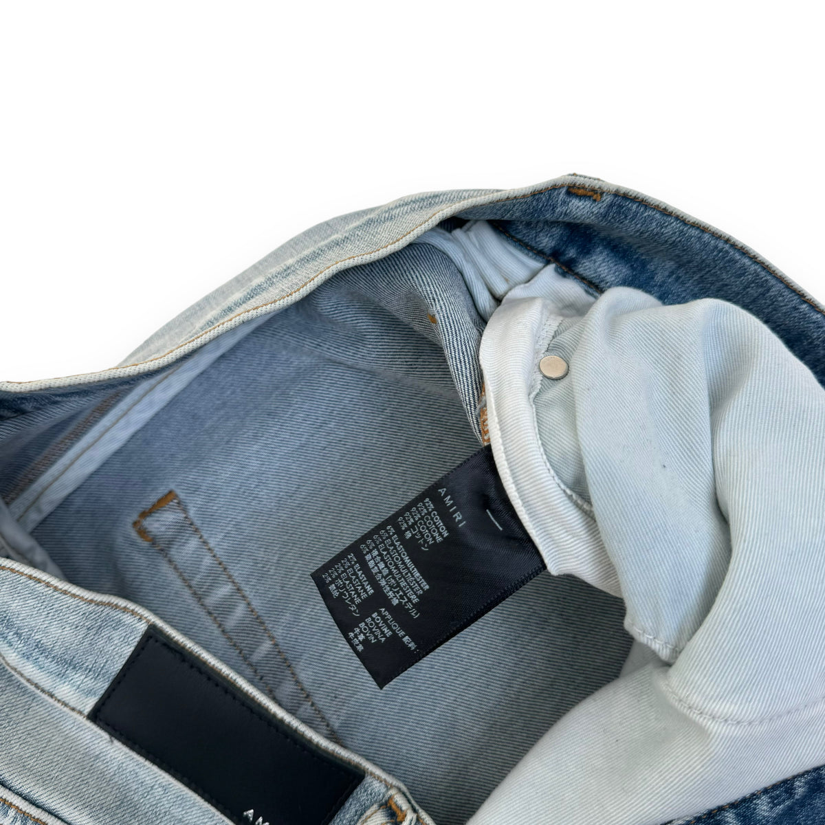 AMIRI DISTRESSED LEATHER PATCH WASHED DENIM JEANS BLUE 36W