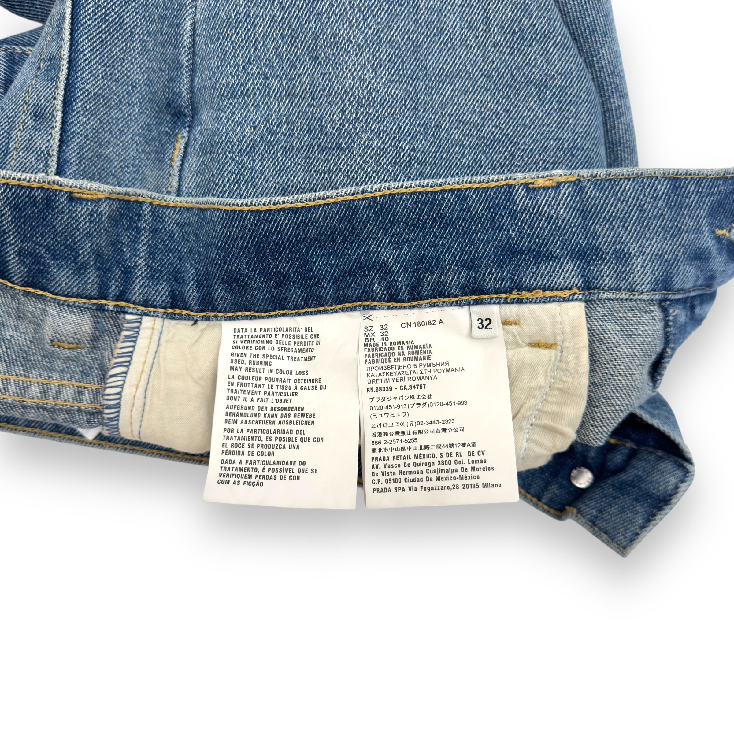 PRADA TRAINGLE-LOGO PLAQUE DISTRESSED DENIM JEANS BLUE W32”